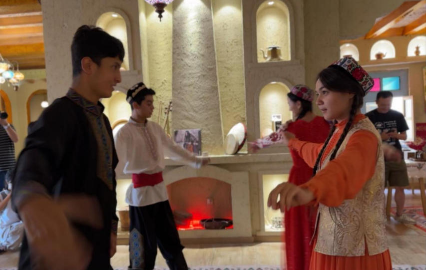 在團(tuán)城一家特色店鋪內(nèi)，演員為游客表演舞蹈。人民網(wǎng)記者 焦磊攝